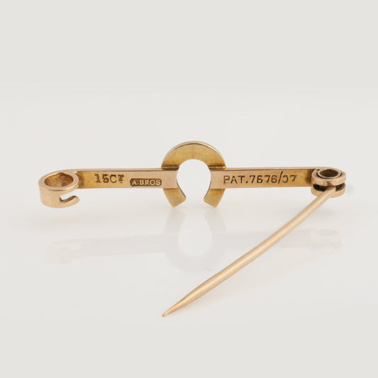 Back of antique 15ct gold horseshoe brooch showing hallmark and patent number