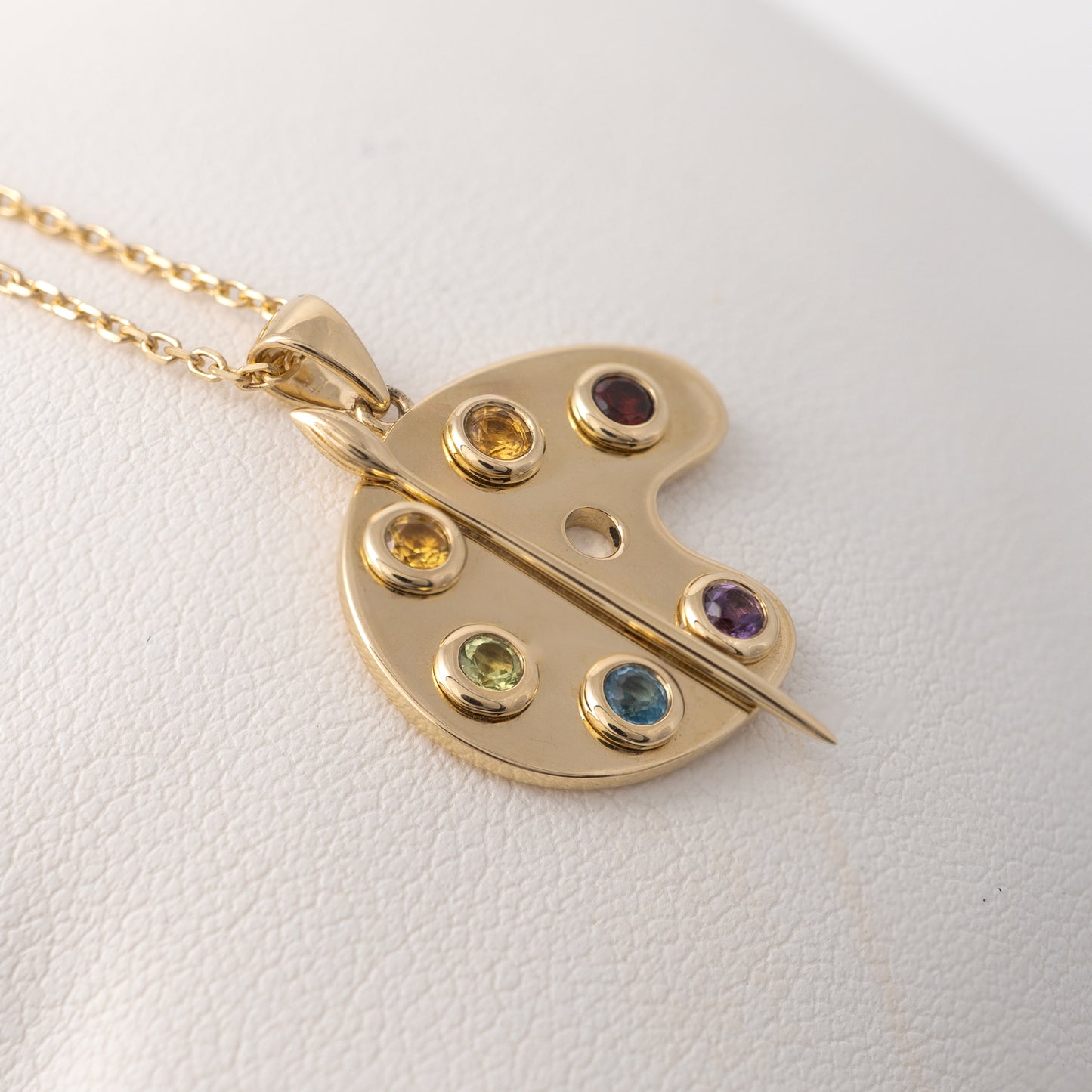 9ct gold palette necklace featuring a paintbrush design semi-precious gemstones bezel setting