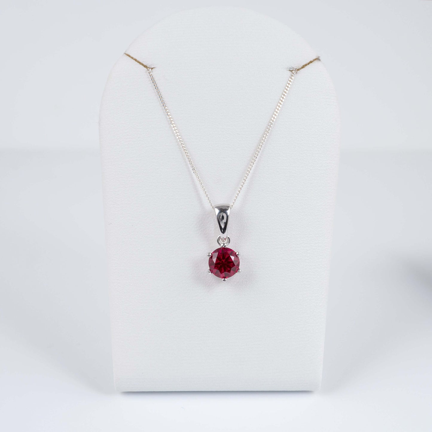 Silver pendant with rhodium plating and ruby gemstone