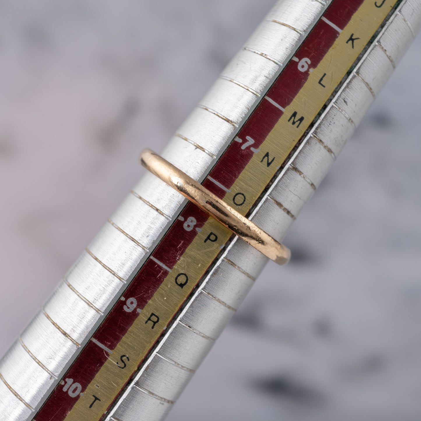gold ring on ring sizer