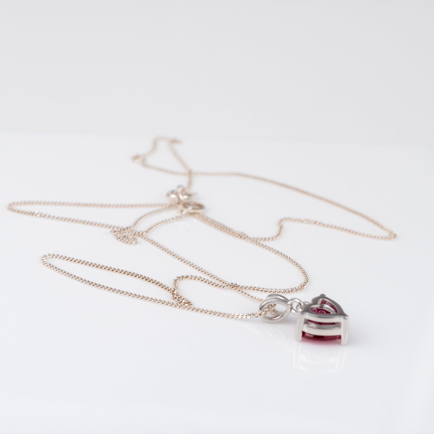 Lab-grown ruby necklace with chain extended to 18 inches