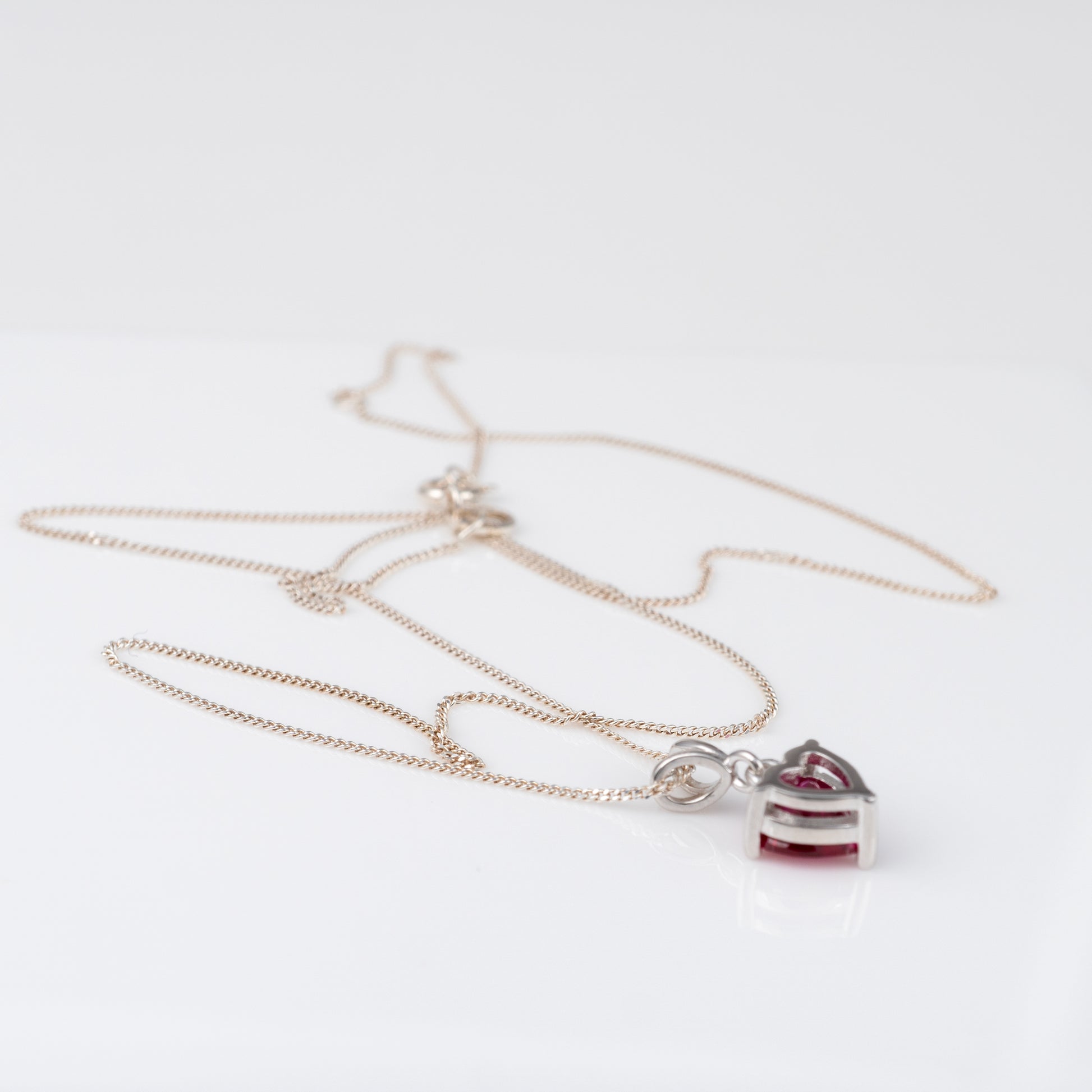 Lab-grown ruby necklace with chain extended to 18 inches