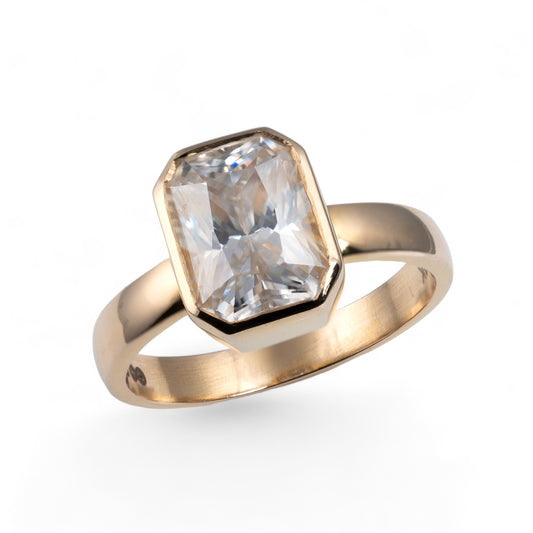 Moissanite ring emerald cut bezel setting yellow gold band