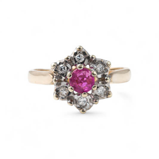 Ruby engagement ring in 9ct yellow gold with diamond halo, floral design