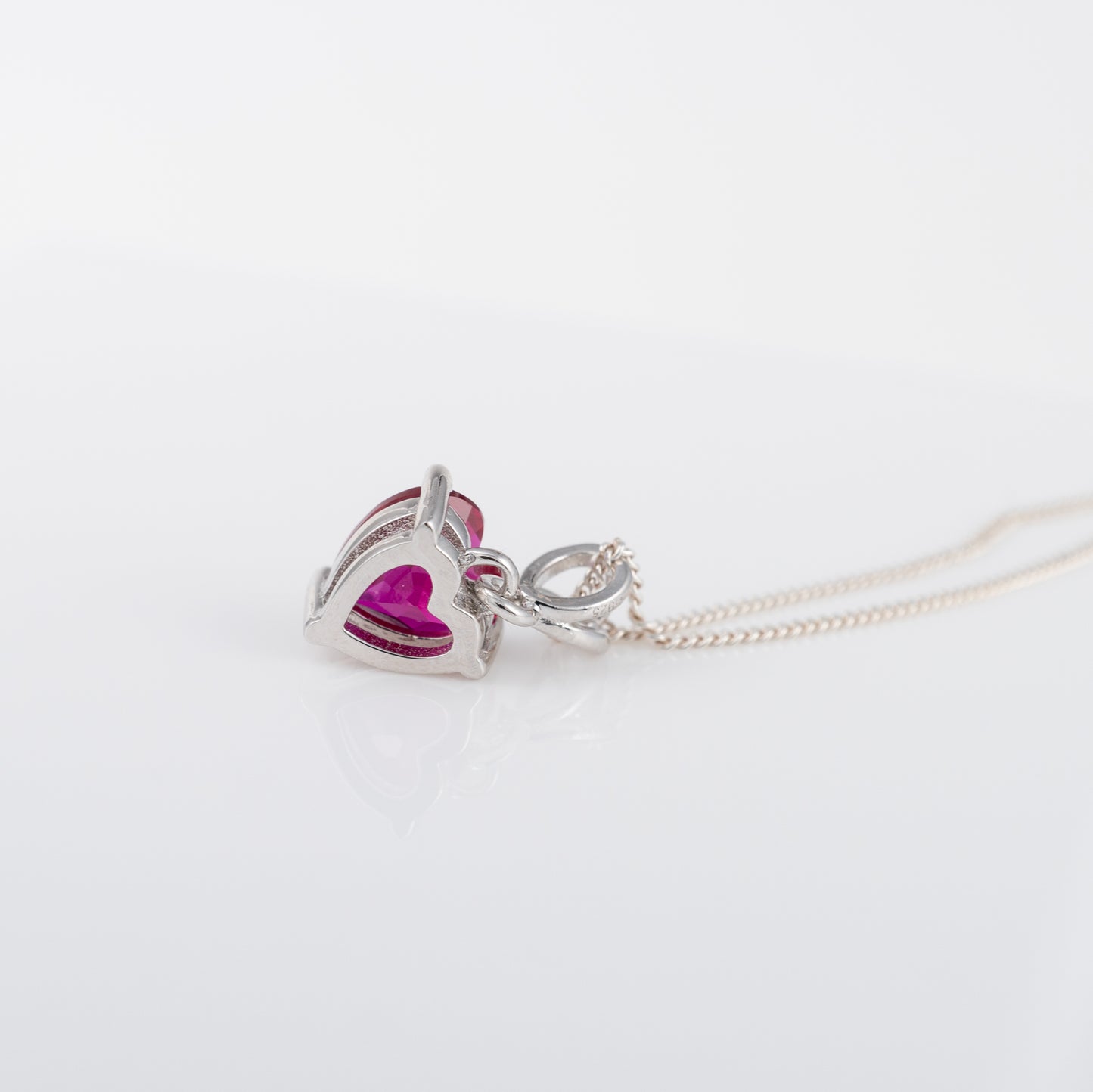 Side view of lab-grown ruby necklace showing prong mount