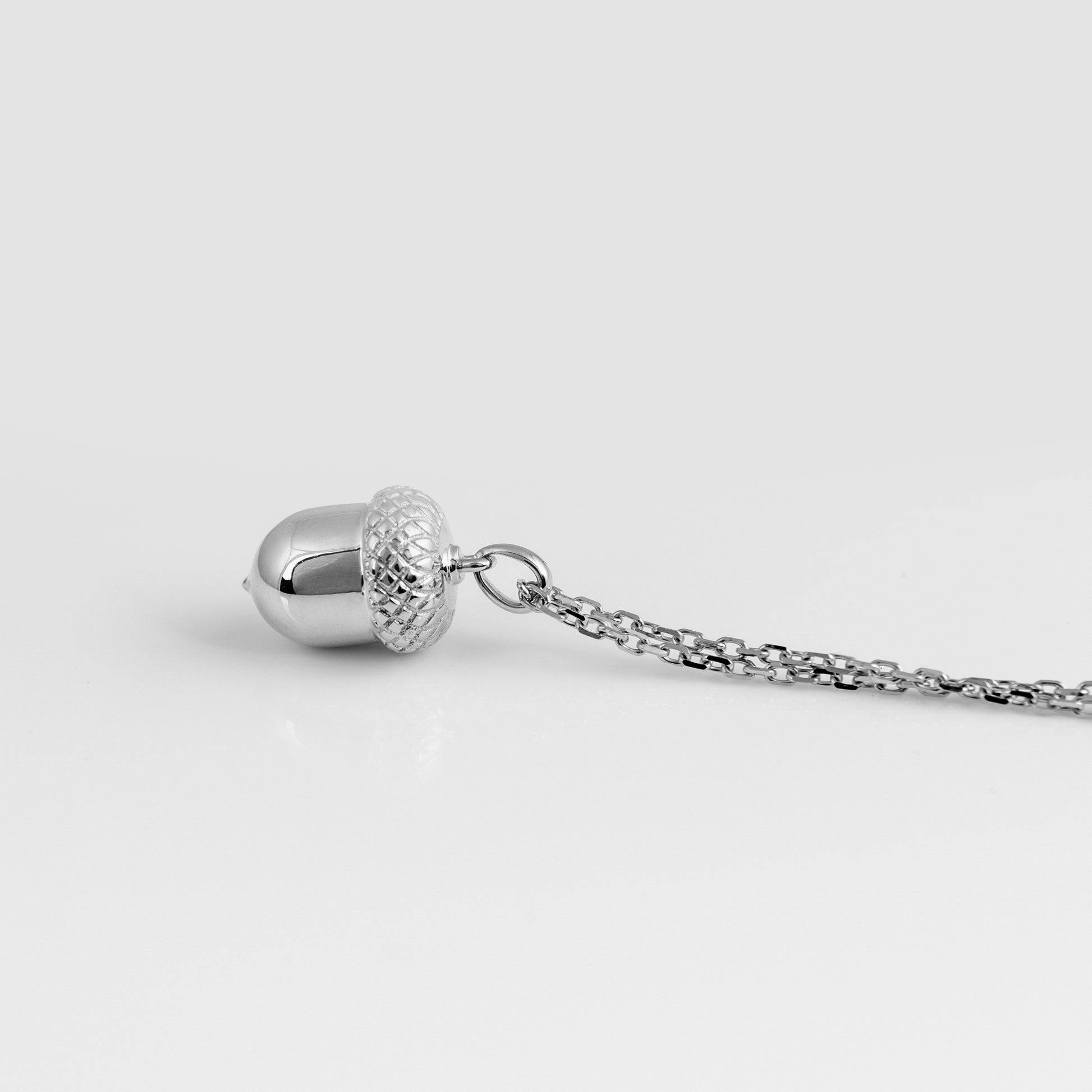 Side angle of 925 silver acorn pendant with chain and cap detail