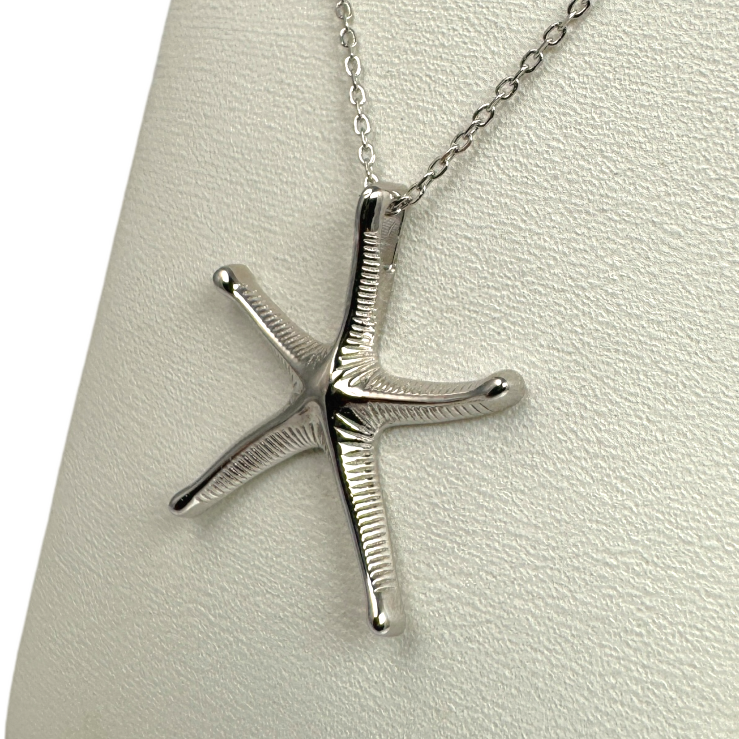 silver starfish necklace showing textured detail integral bail