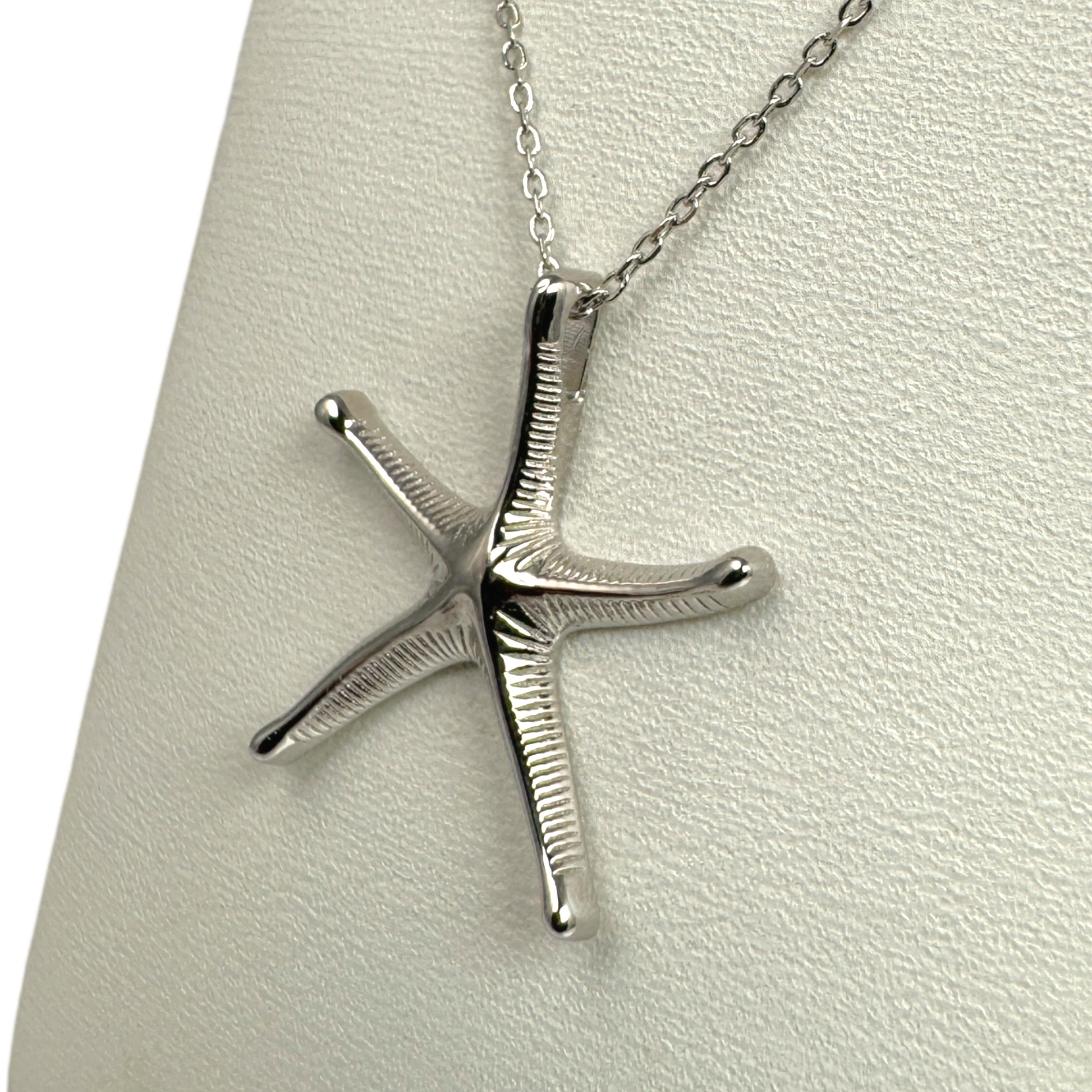 silver starfish necklace showing textured detail integral bail