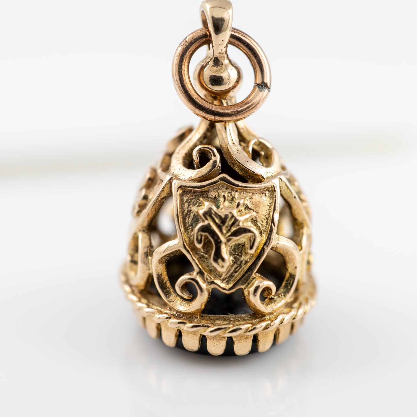 Vintage 9ct gold fob with fleur-de-lis motif and ornate scroll design