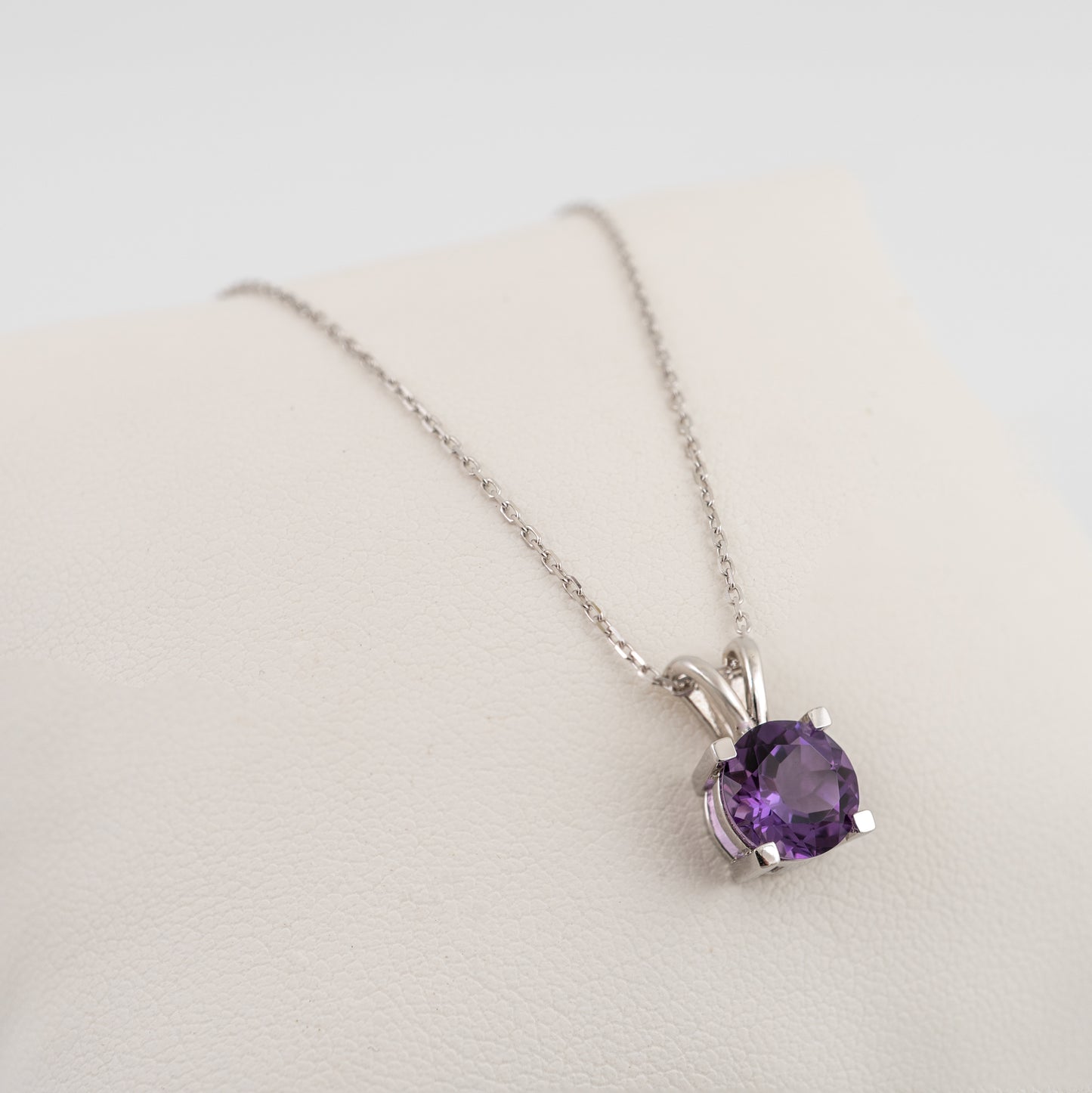 round-amethyst-pendant-necklace-on-white-display