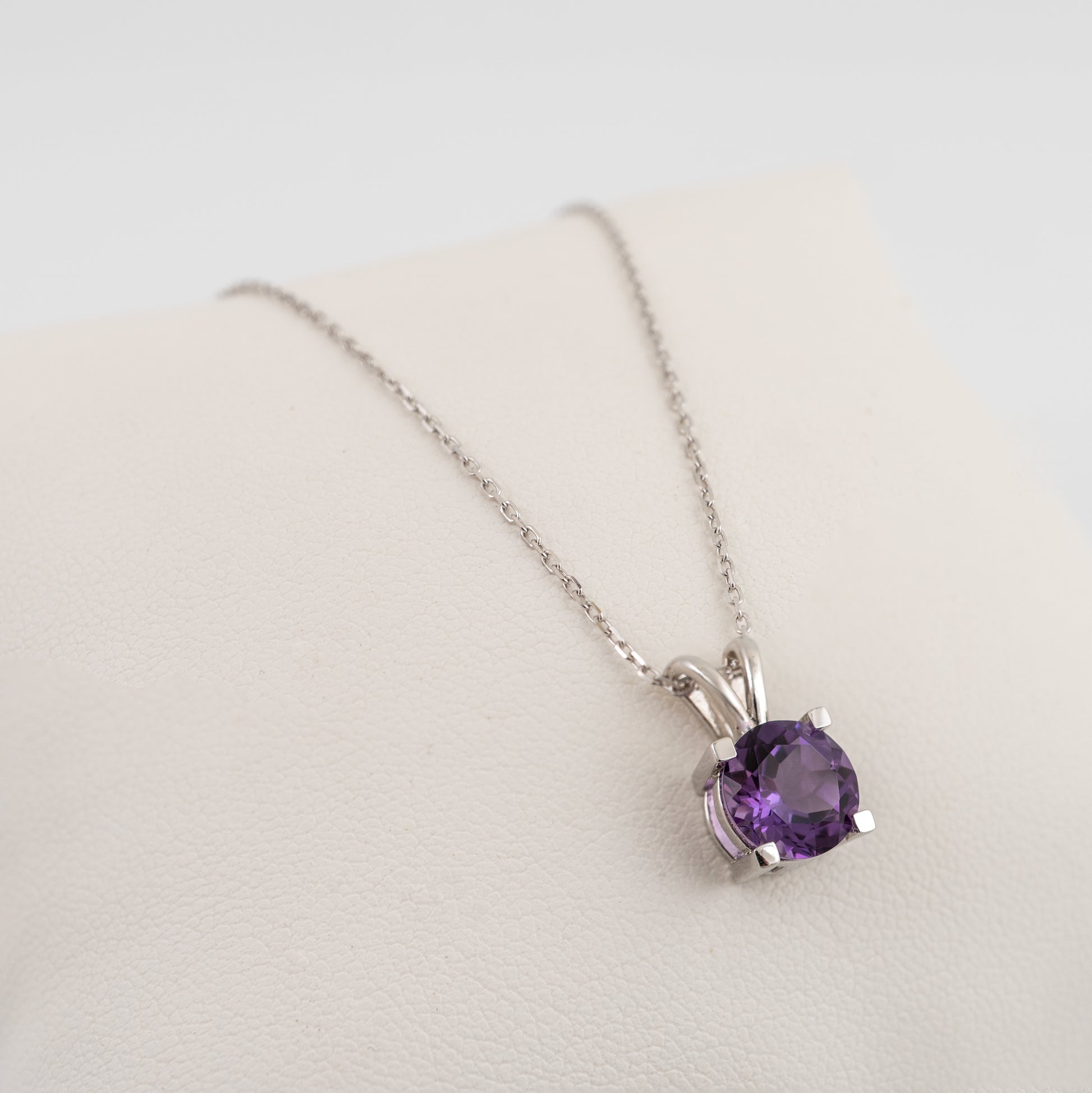 round-amethyst-pendant-necklace-on-white-display