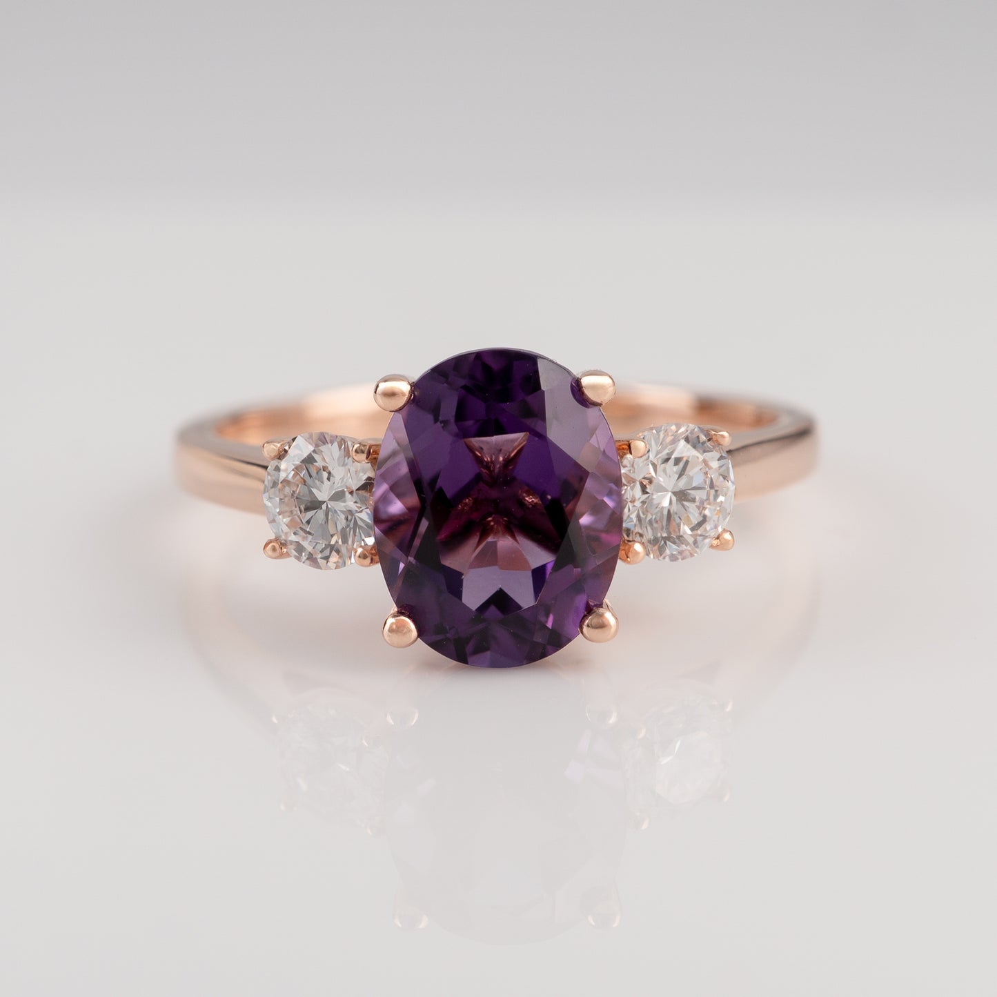 Classic amethyst three stone ring in rose gold with diamonds – close up