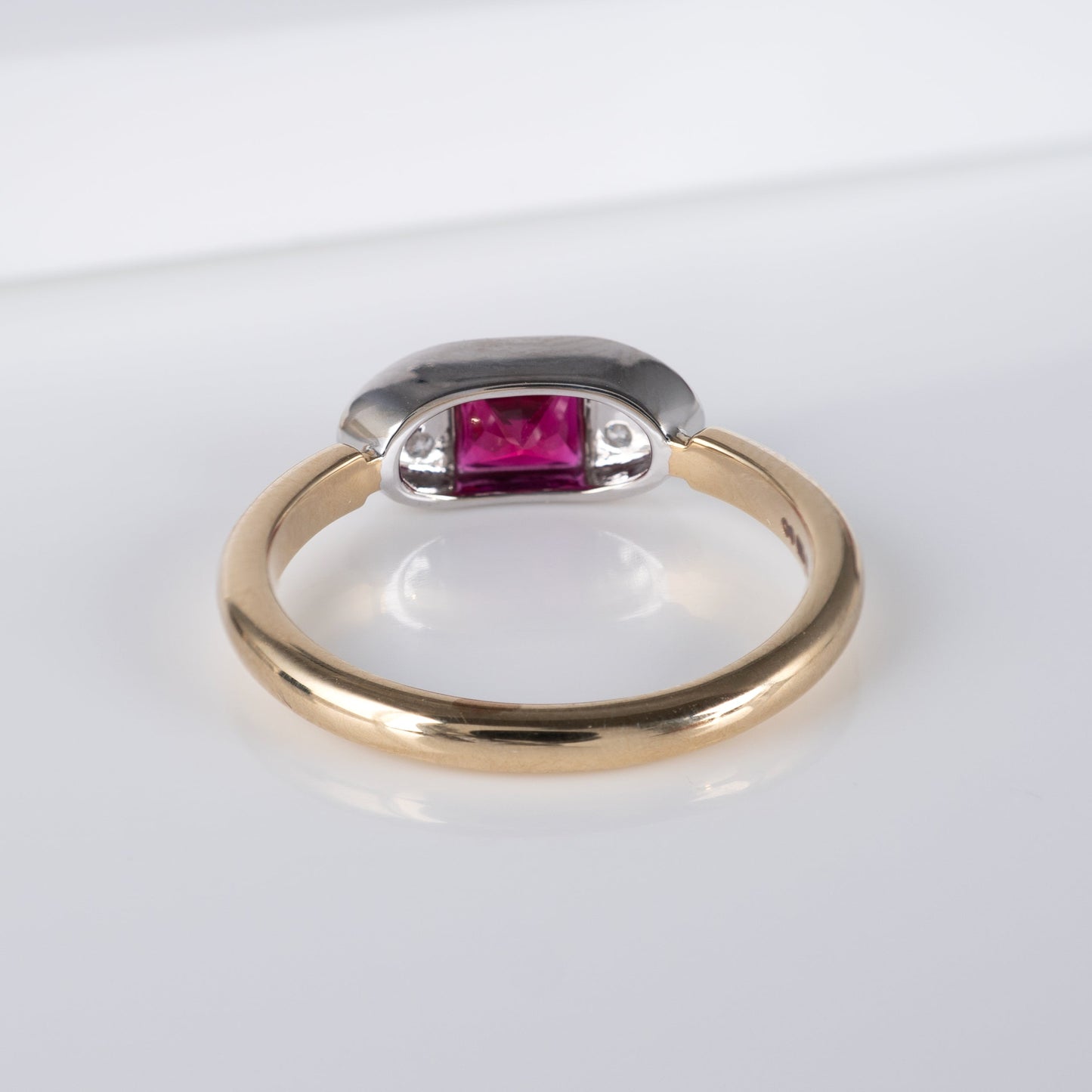 back view of contemporary ruby ring in 9ct gold, showcasing radiant-cut lab ruby and diamond accents by Hunters Fine Jewellery.