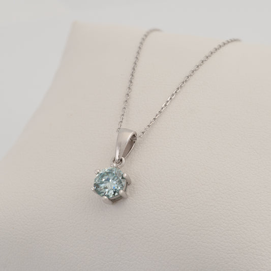 Pale blue moissanite necklace pendant displayed on jewellery card