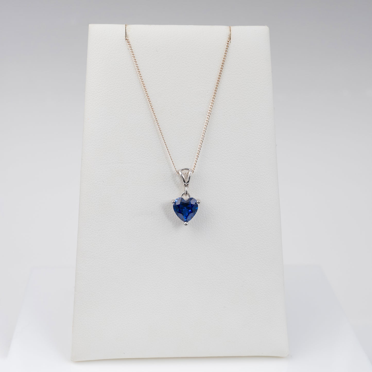 Lab-grown blue sapphire heart necklace on display stand – perfect gift idea