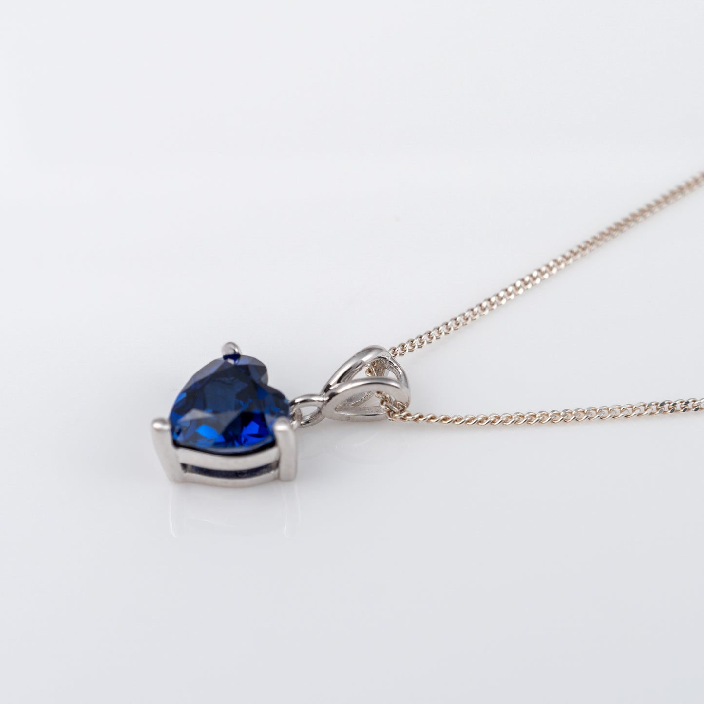 Close-up of lab-grown blue sapphire heart pendant and chain – Hunters Fine Jewellery