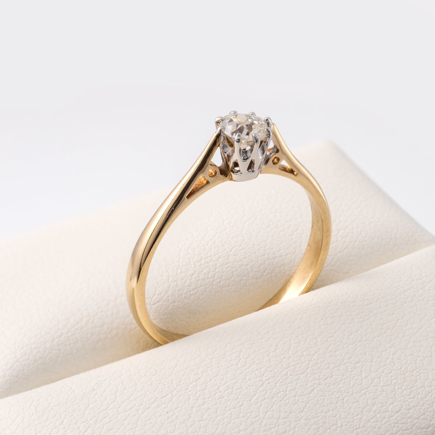 Close-up of old European cut diamond in 9ct gold shank with white gold setting