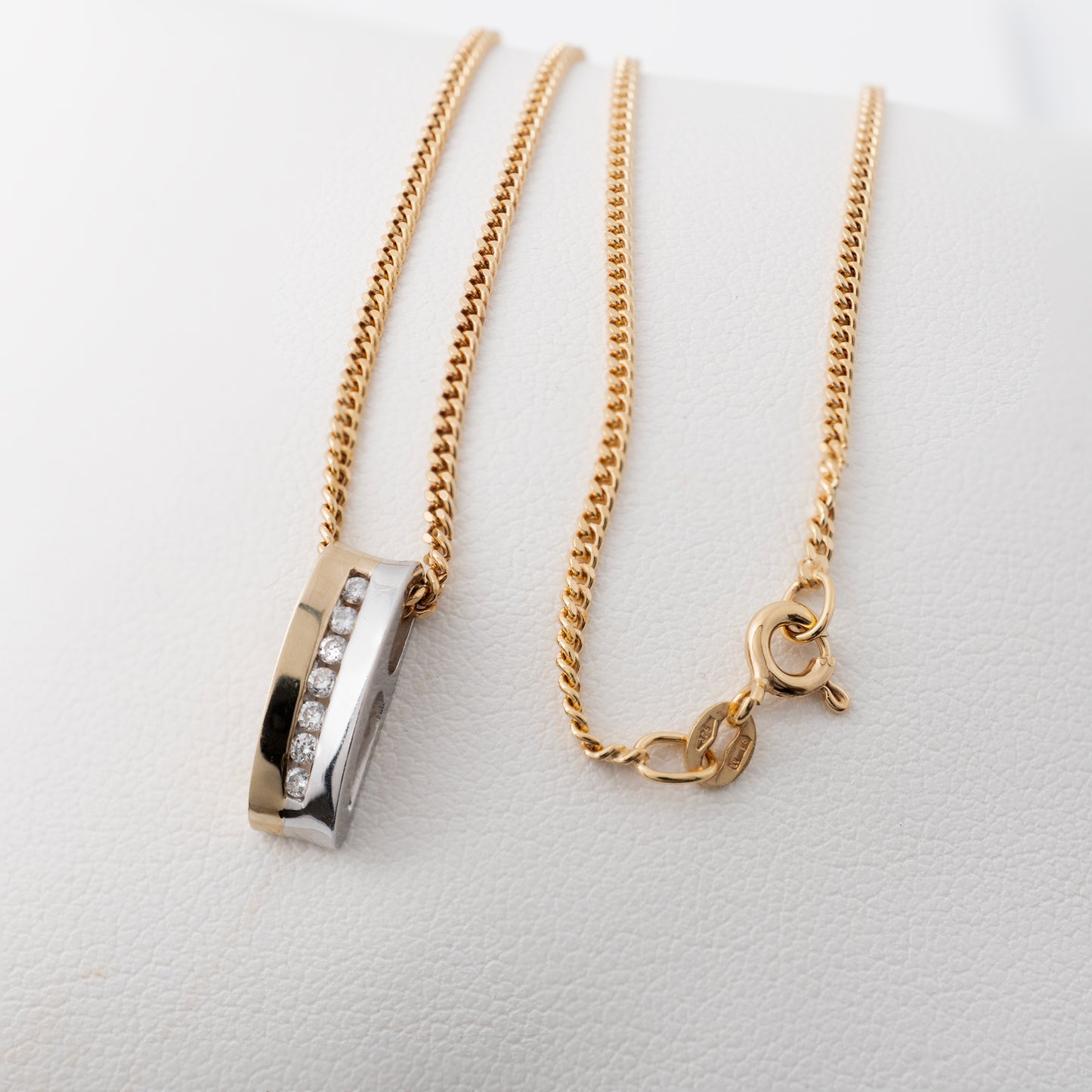 Two-tone gold diamond bar necklace close-up with chain clasp