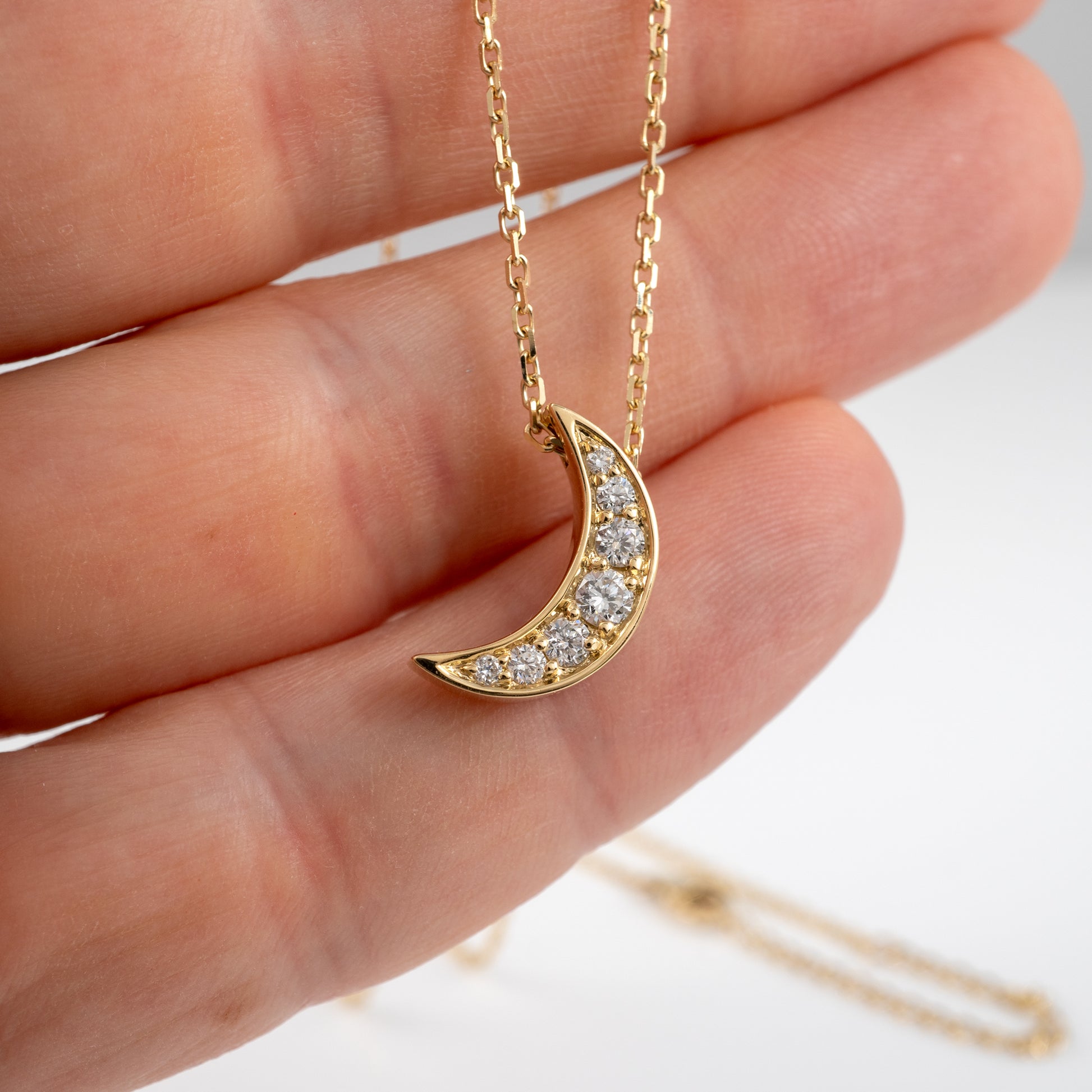 Lab Grown Diamond Moon crescent Necklace in hand showing scale