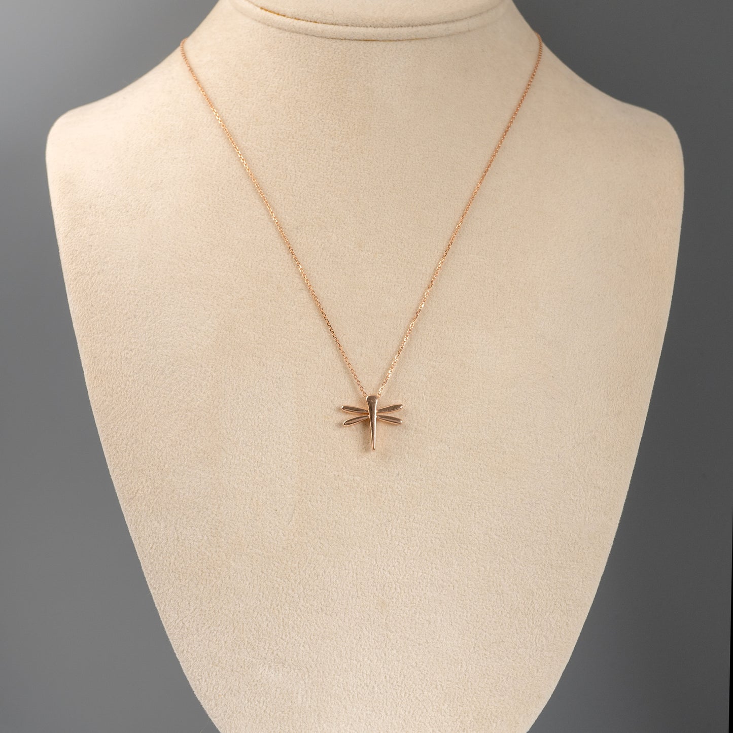 9ct rose gold dragonfly pendant shown on mannequin display bust to show scale