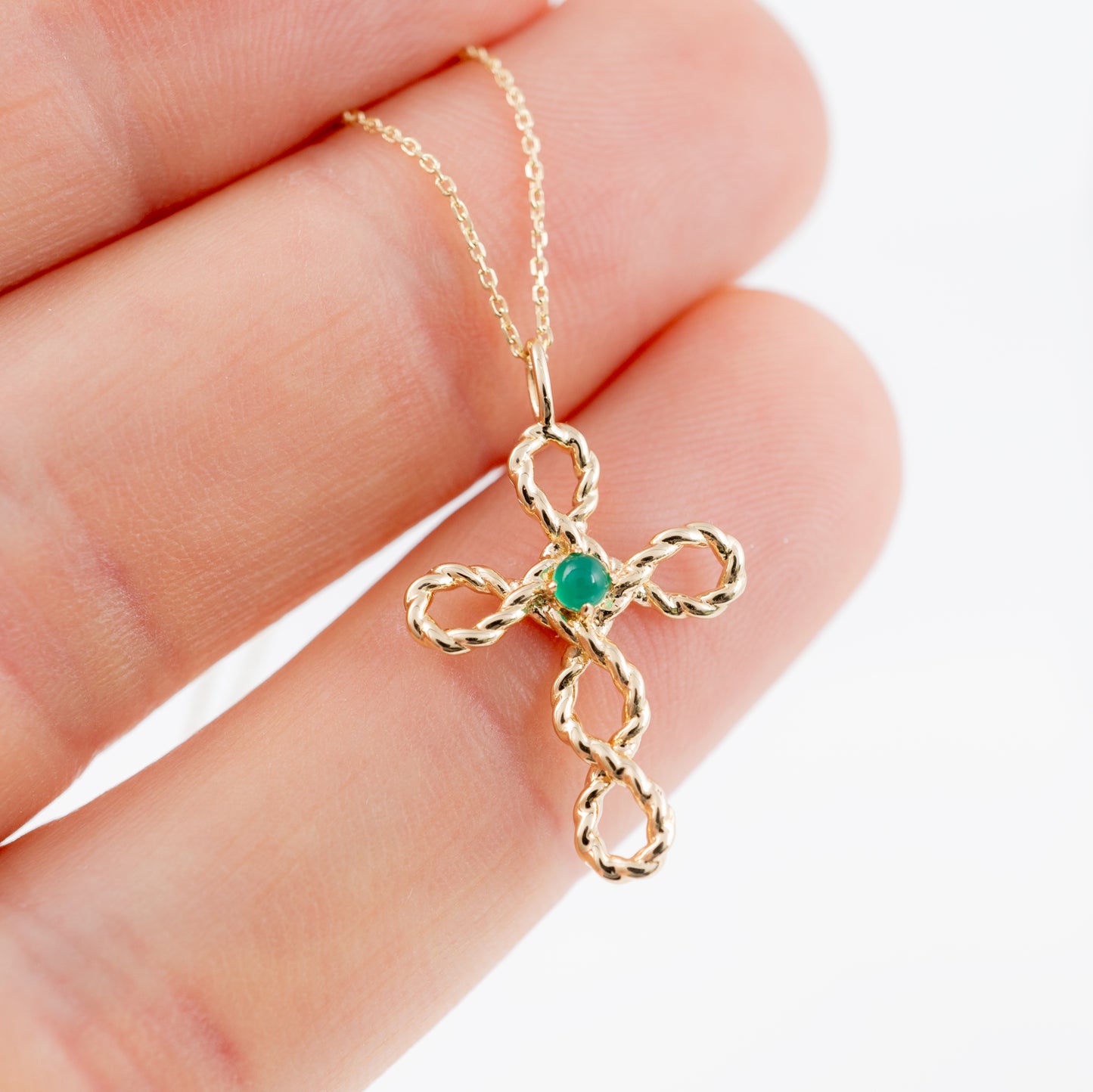 Gold cross pendant necklace with green onyx – held to show chain detail
