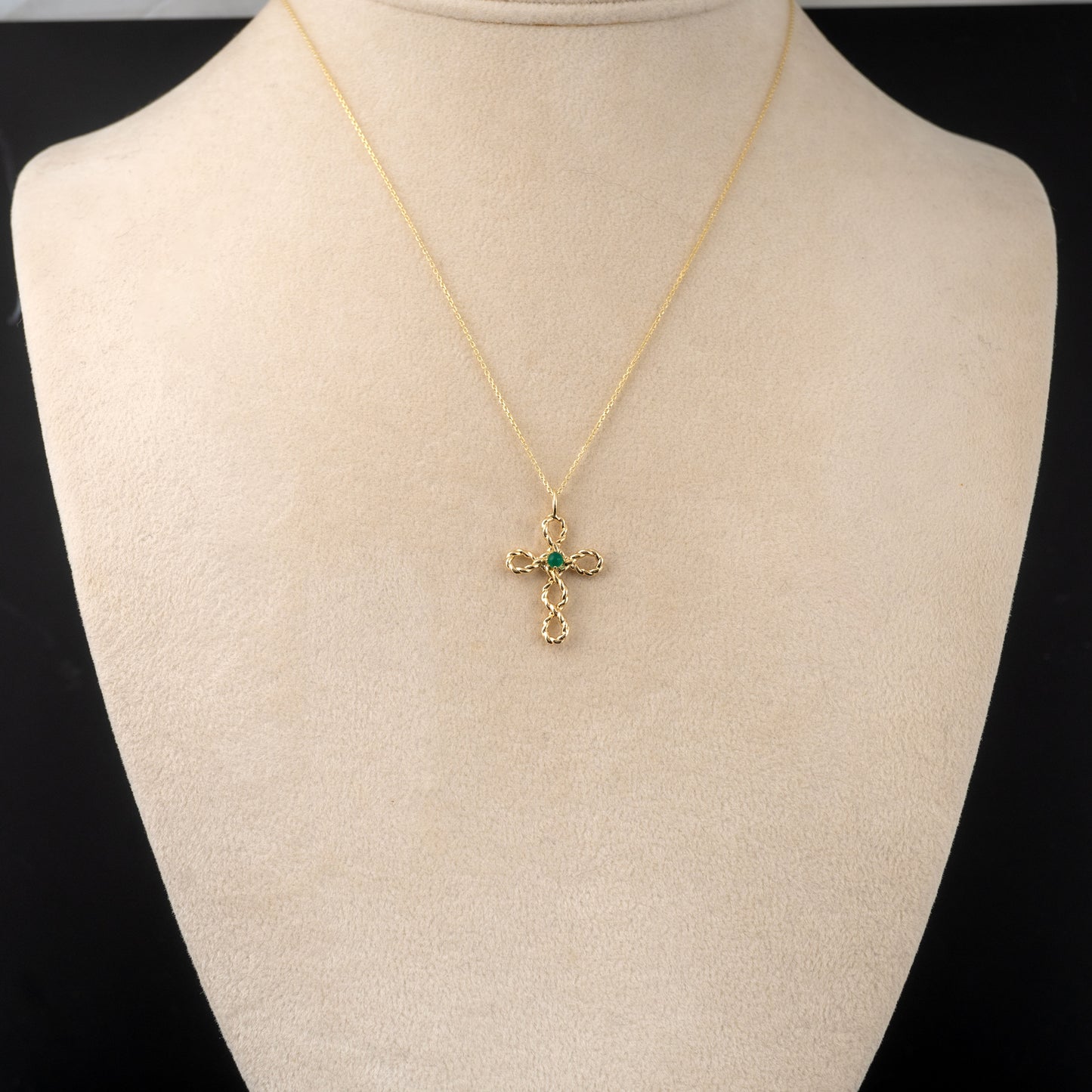 Gold cross necklace with green onyx gemstone – worn on model bust