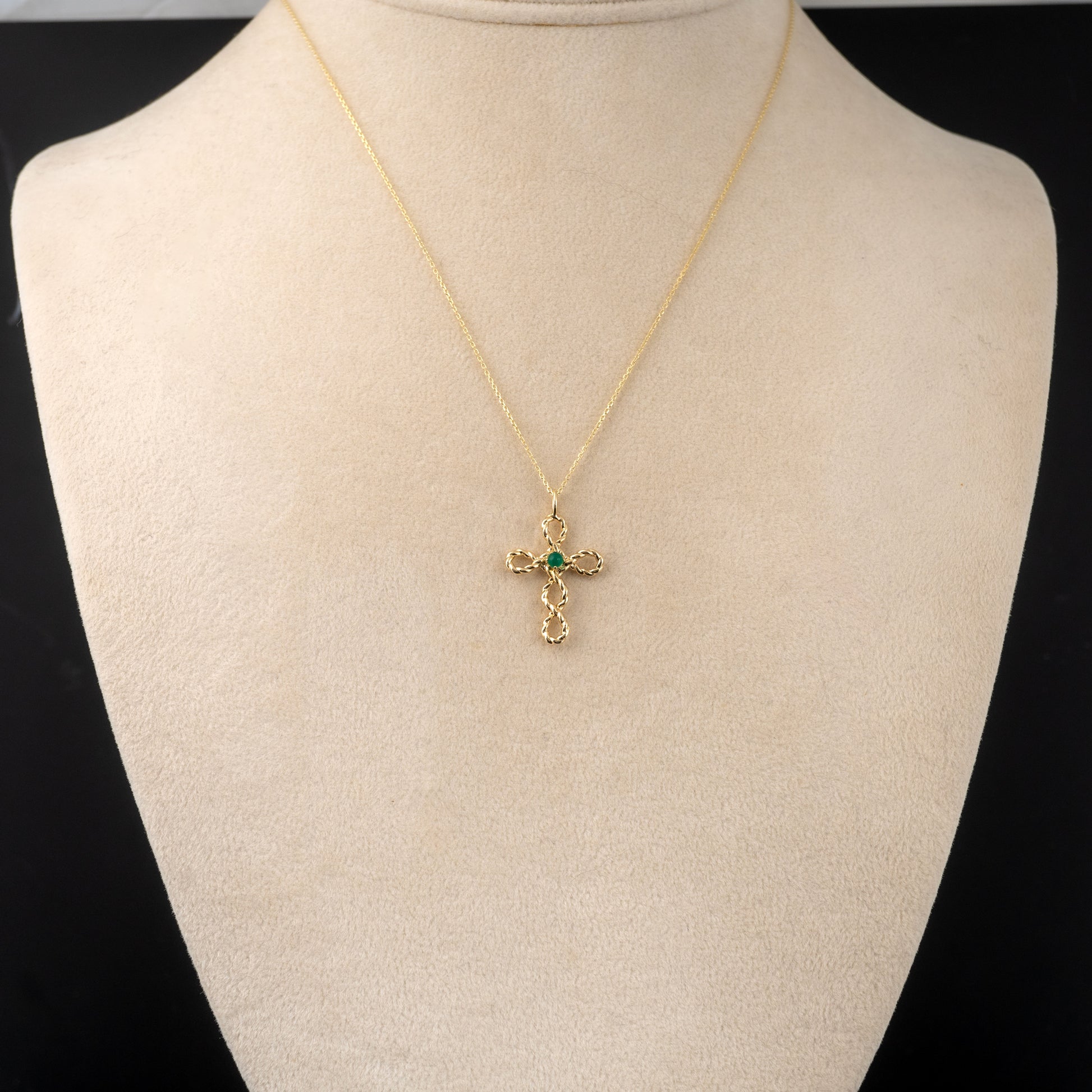 Gold cross necklace with green onyx gemstone – worn on model bust