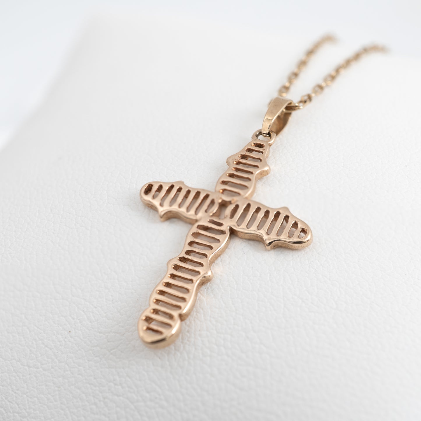 Close-up of vintage 9ct gold crucifix necklace with linear design by Hunters Fine Jewellery