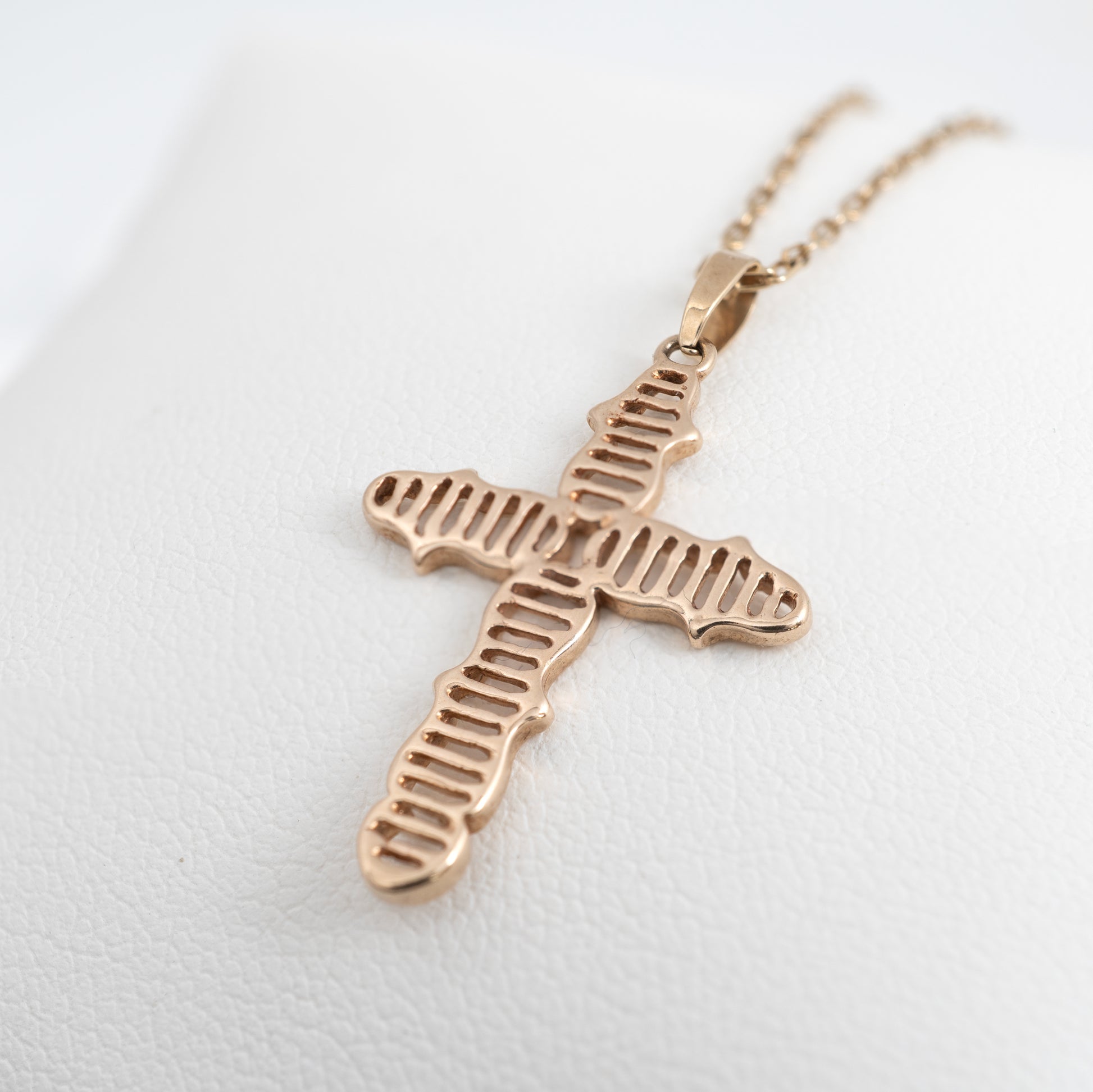 Close-up of vintage 9ct gold crucifix necklace with linear design by Hunters Fine Jewellery