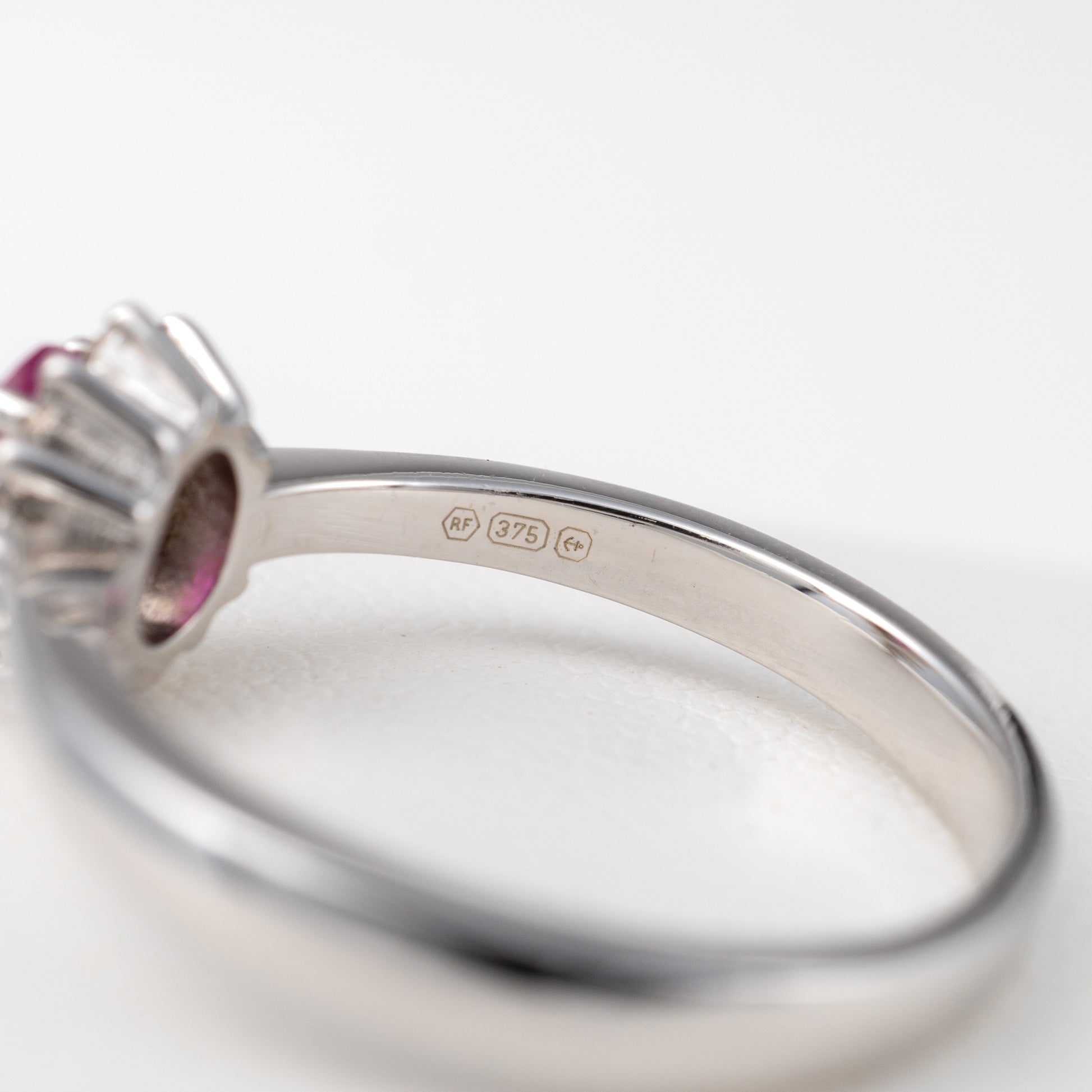 Close-up-of-Hallmark-on-Ruby-Diamond-Halo-Ring-in-White-Gold