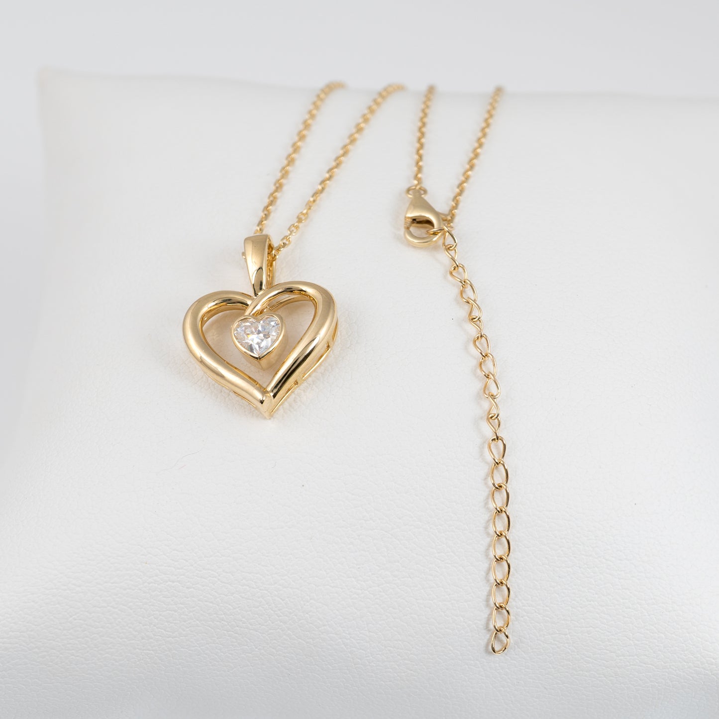 Gold heart necklace showing the extendable chain length