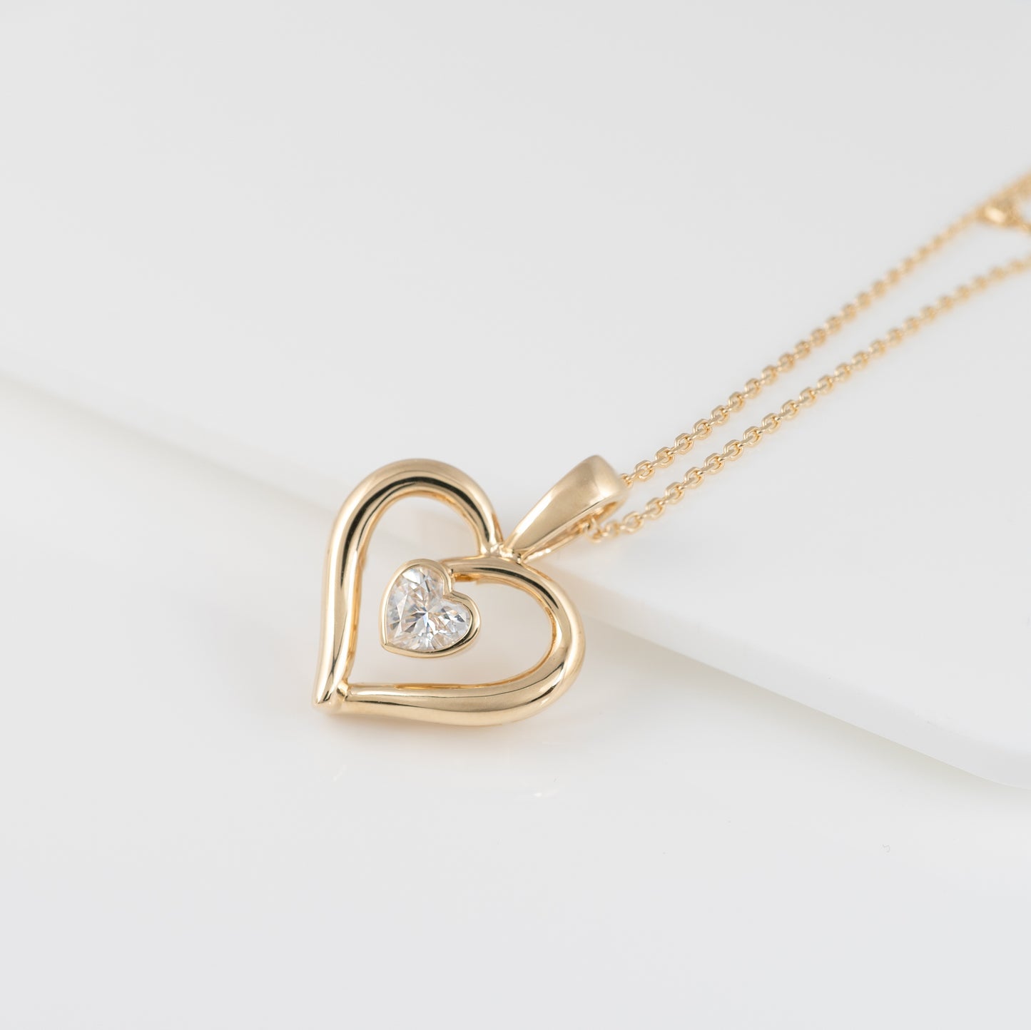 9ct gold heart necklace with moissanite – flat lay on white