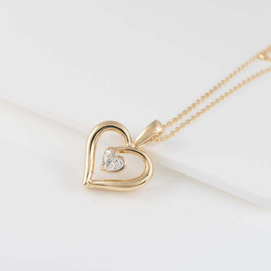 9ct gold heart necklace with moissanite – flat lay on white