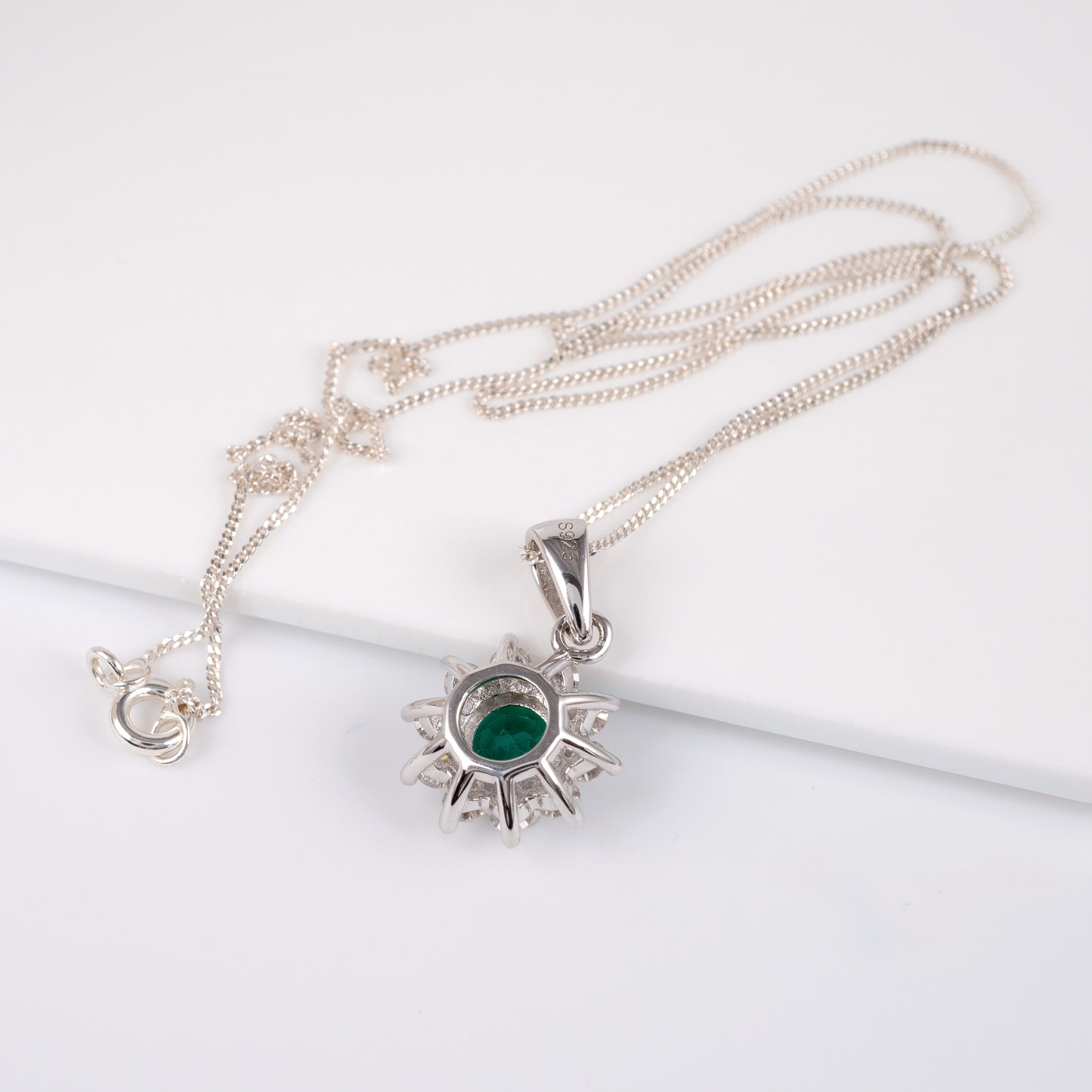 Lab grown emerald necklace with adjustable silver curb chain – flat lay view