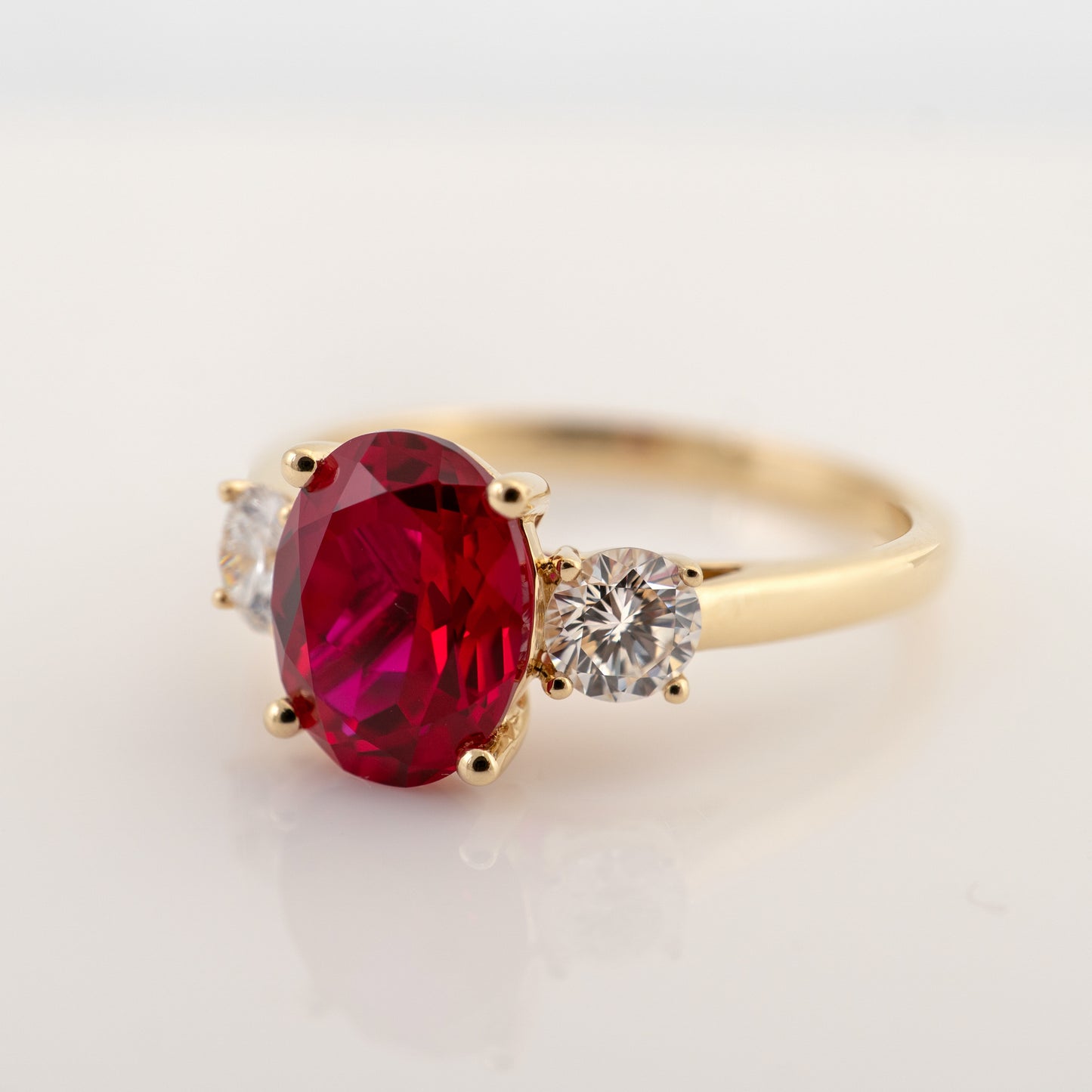 Side view of lab grown ruby ring in yellow gold with lab diamonds