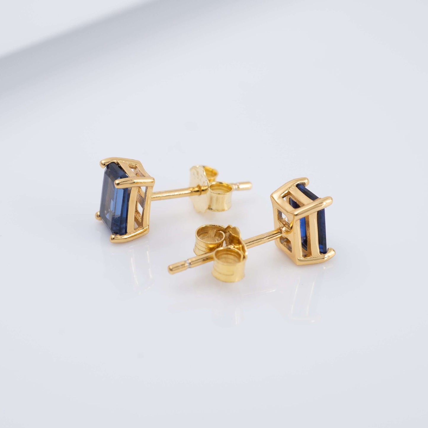 lab blue sapphire studs earrings gold side