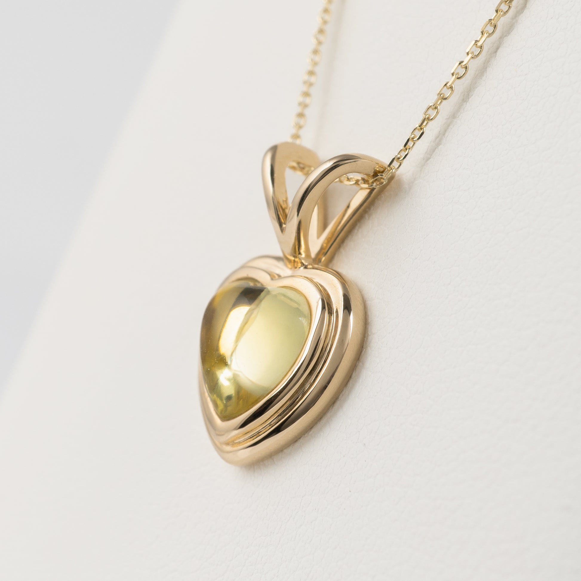gold heart necklace with olive green gemstone