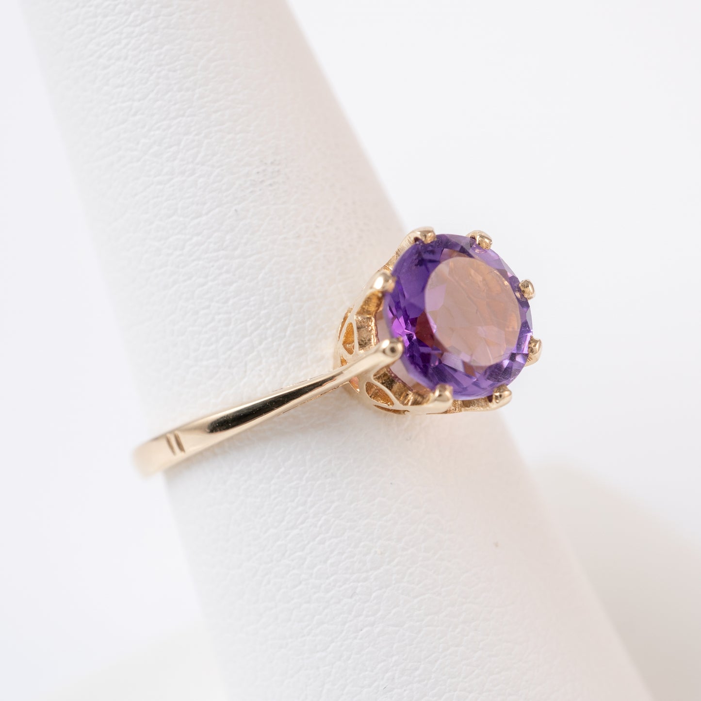 vintage amethyst solitaire ring angled view round gemstone prong setting