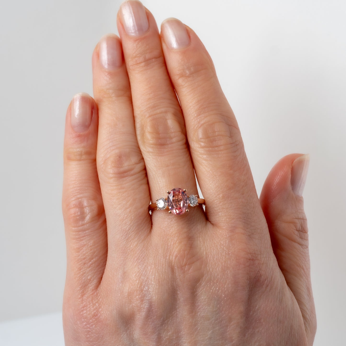 Hunters Fine Jewellery lab created sunrise padparadscha sapphire ring worn on hand