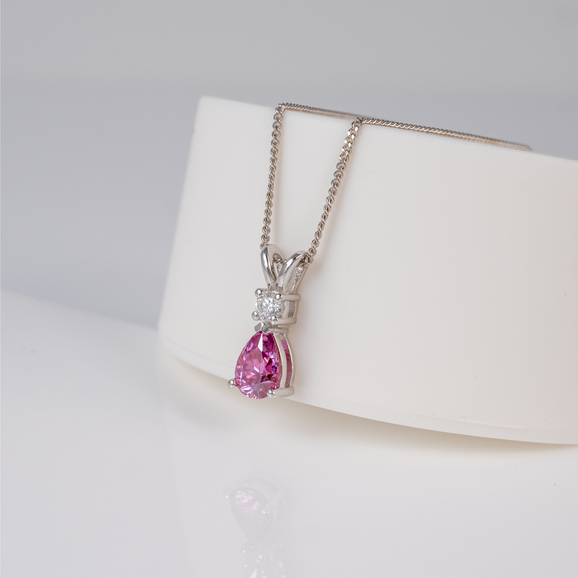 Sterling silver pink moissanite necklace on display stand