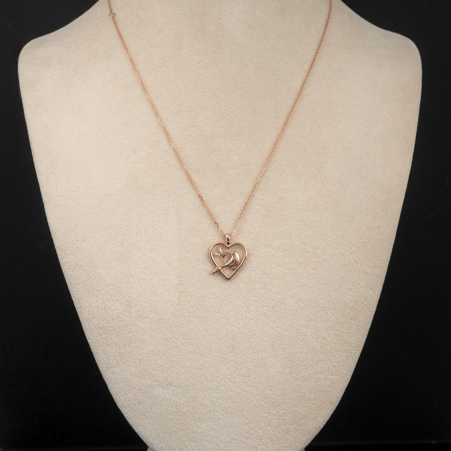 gold bird necklace on display bust showing chain length