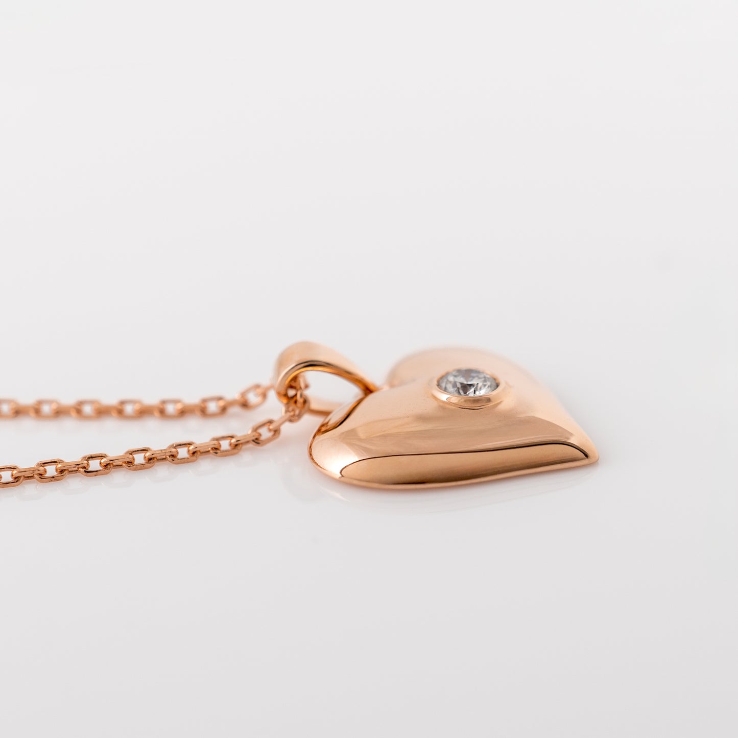 Rose gold heart necklace showing side profile with lab-grown diamond