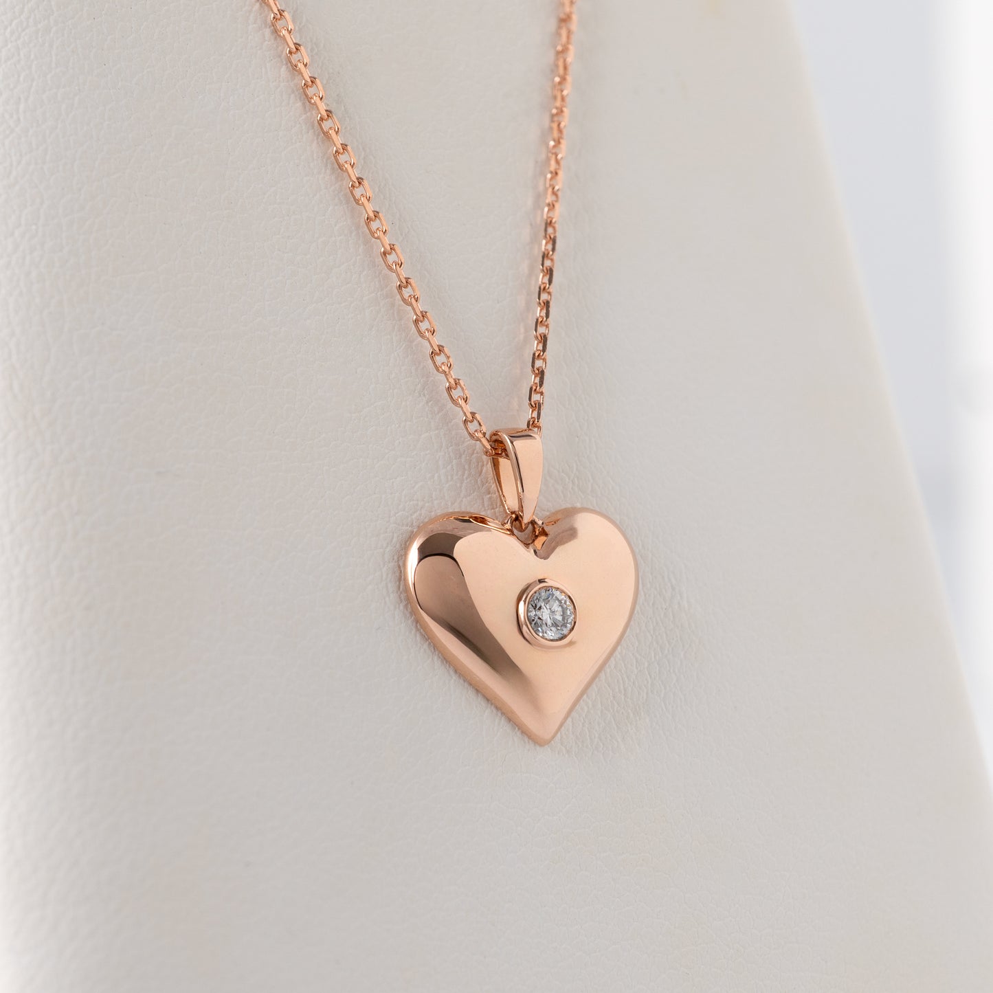 Polished 9ct rose gold heart necklace with ethical lab-grown diamond.