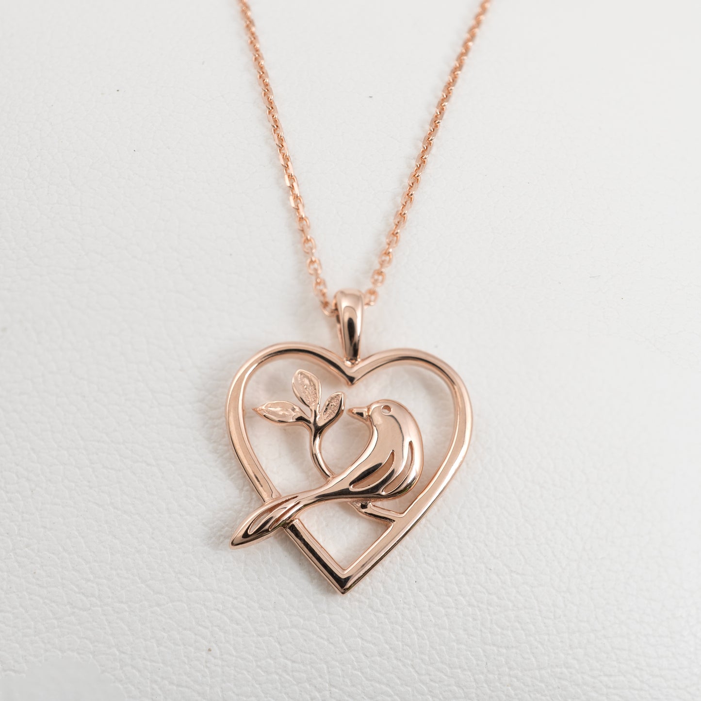 rose gold heart necklace with bird on branch