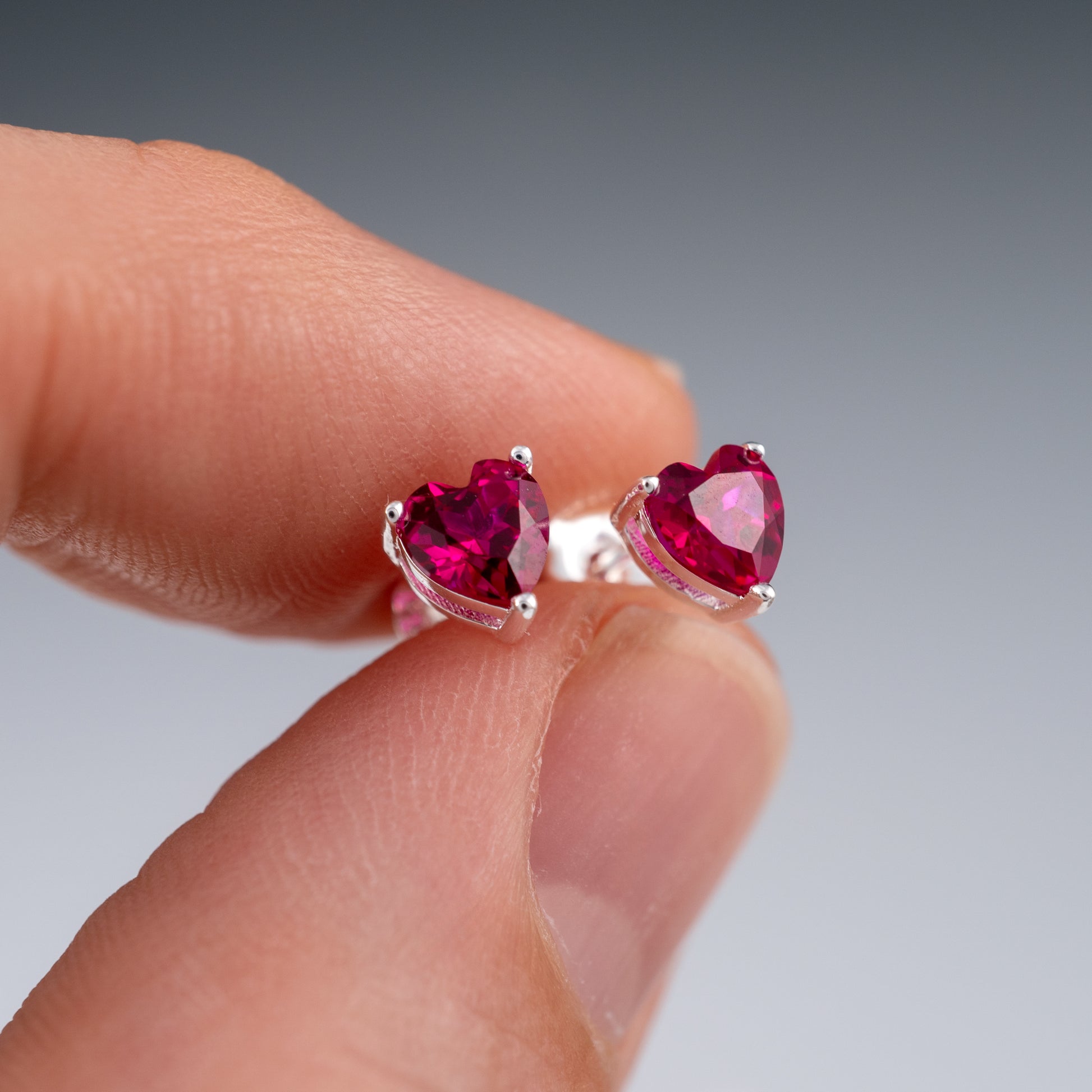 ruby-heart-earrings-in-hand-showing table facets