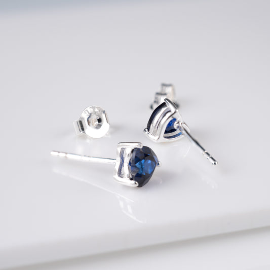 Blue lab sapphire heart earrings with butterfly backs – side view