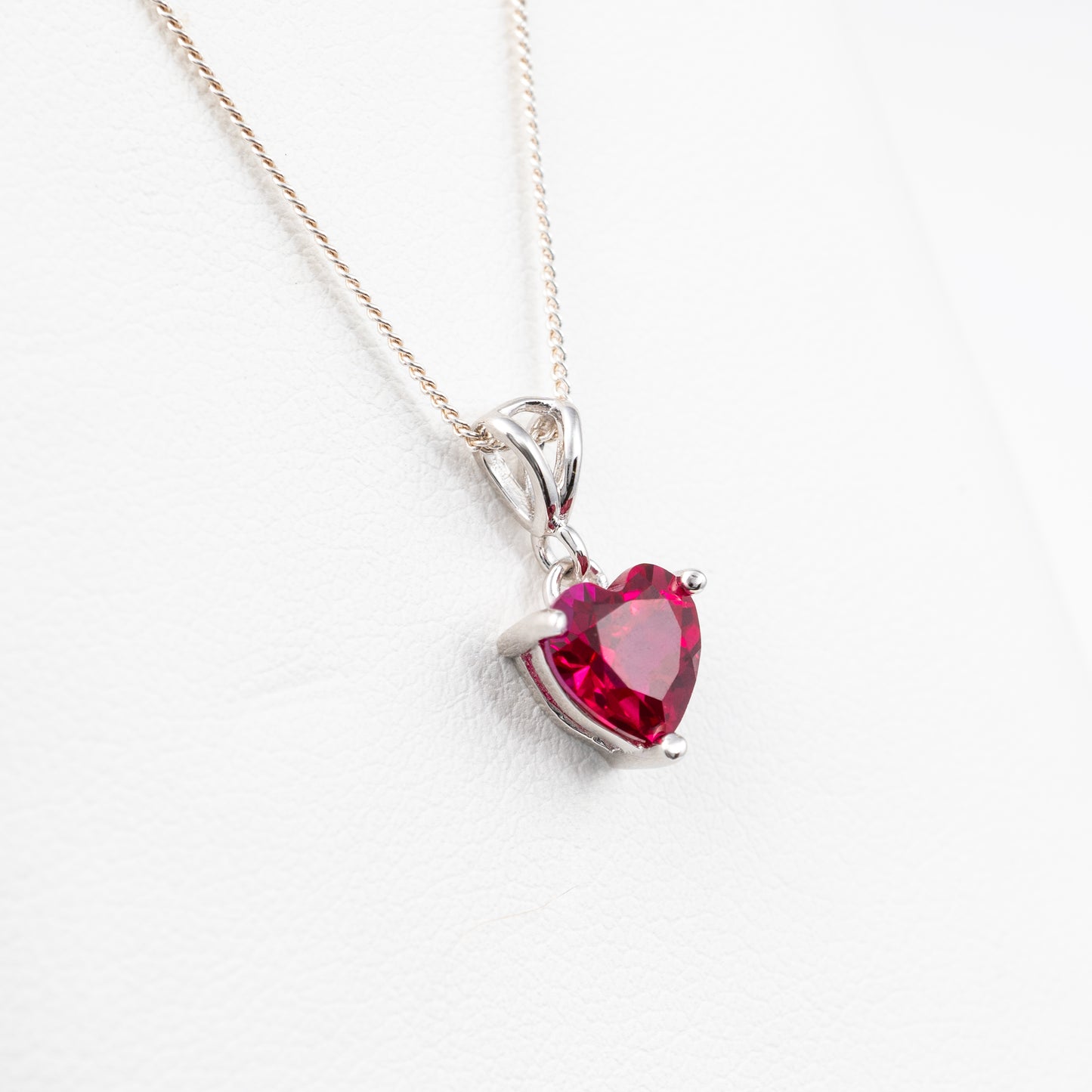 side view of lab-grown ruby heart necklace in sterling silver