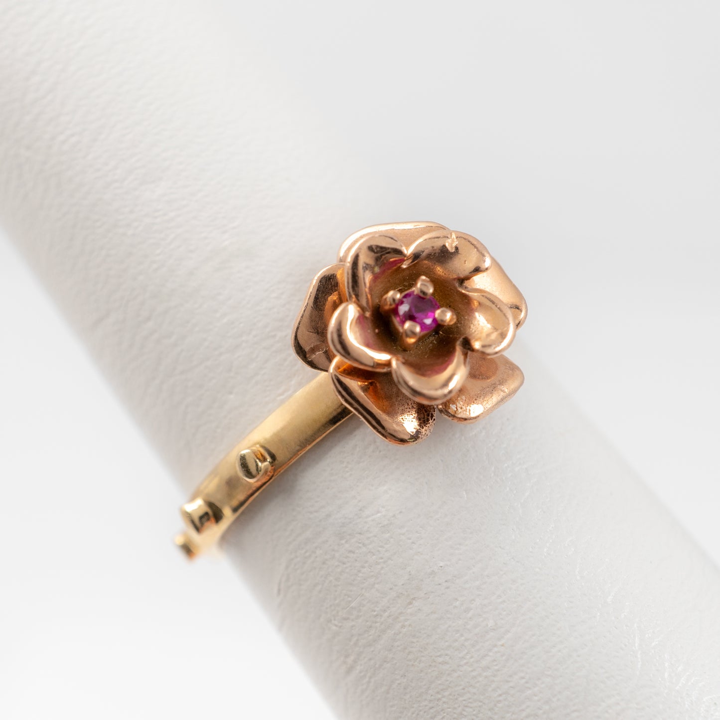 side view 14K gold rosary ring with a rose gold flower setting and ruby gemstone