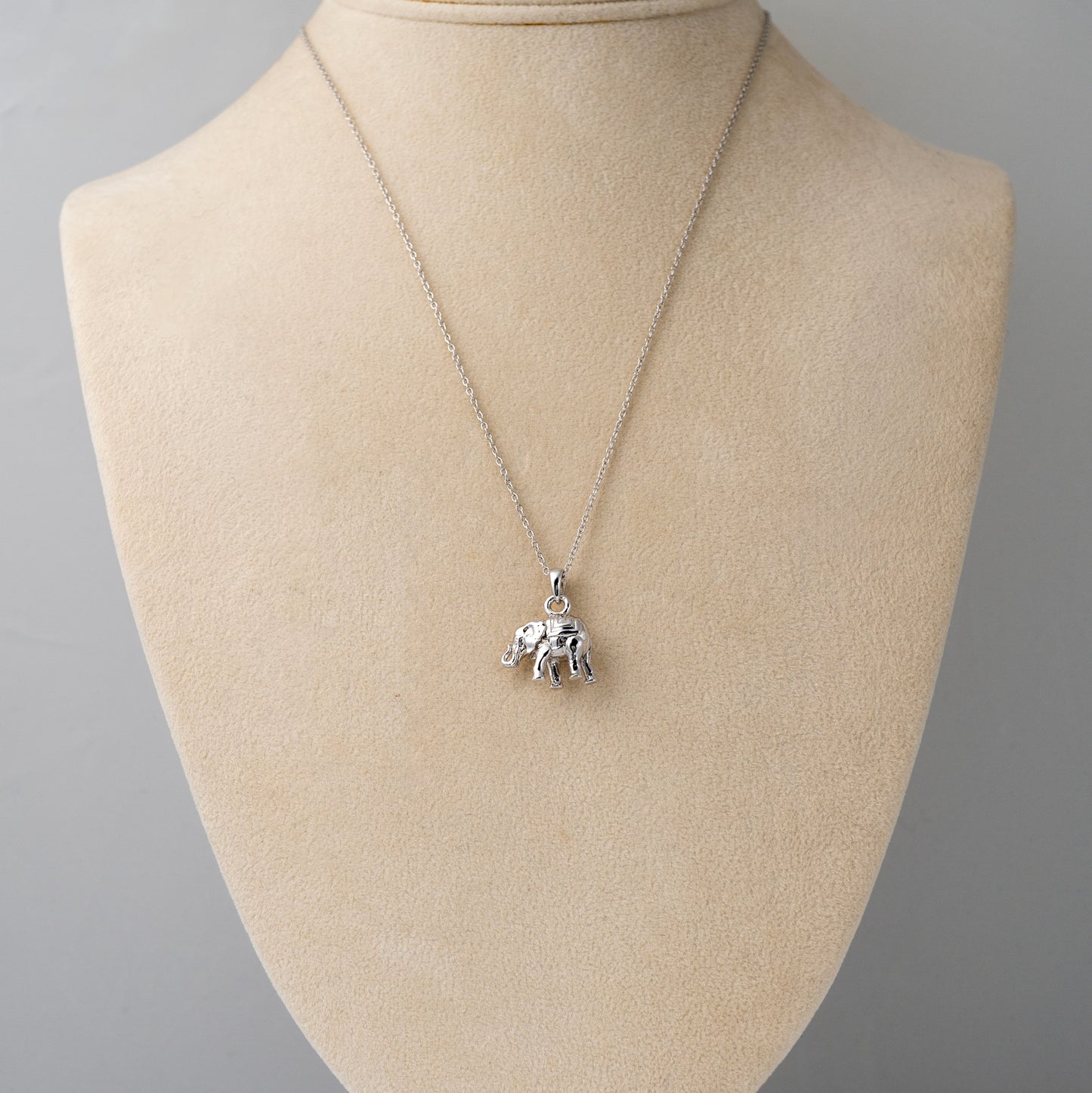 Lucky elephant necklace shown on mannequin bust for scale