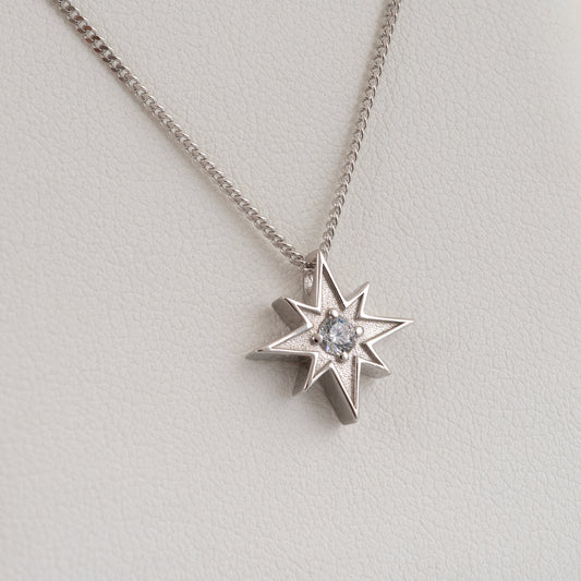 angled view of silver North Star necklace with clear stone